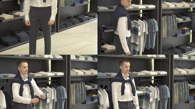 一位时尚的年轻男性客户在男性服装店的陈列室展示新面貌的底部照片。多种选择。商店和销售概念。