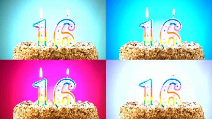 带有燃烧的生日蜡烛的生日蛋糕。16号。背景改变颜色