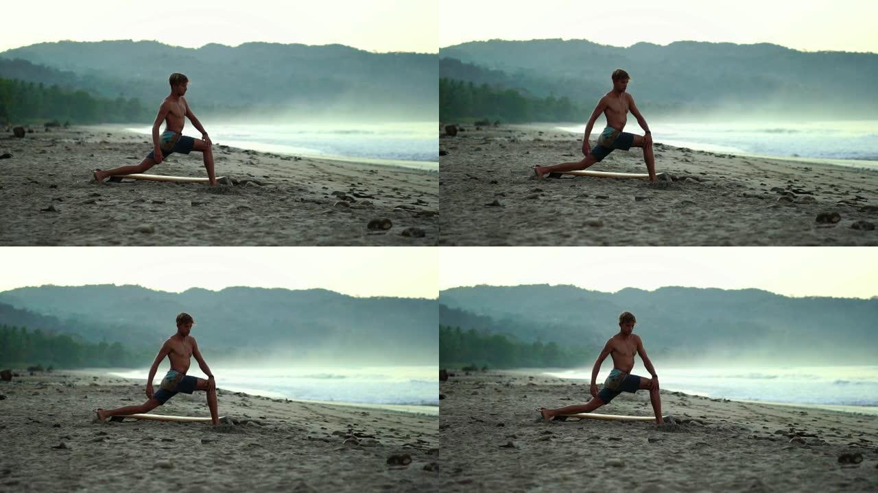 男性千禧一代做瑜伽伸展健身。肌肉健康的男人在日出时在海滩练习瑜伽