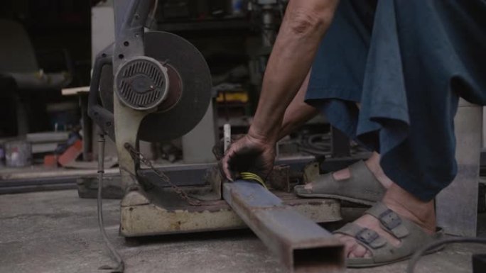 年长的男性正在准备一些用于切割钢材的钢材。