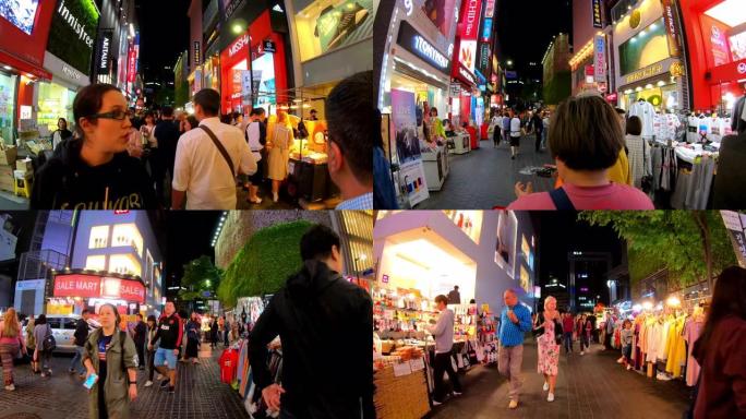 明洞市场的超延时。韩国首尔，人们晚上在购物街上散步