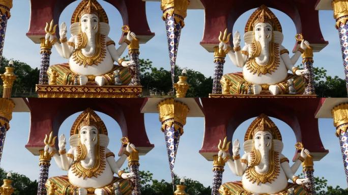 印度教寺庙中的甘尼萨雕像。加纳帕蒂雕像，金色装饰和象头，位于亚洲国家阳光明媚的传统印度教寺庙的院子里