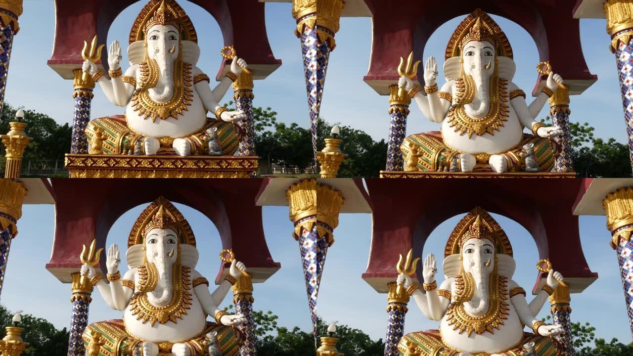 印度教寺庙中的甘尼萨雕像。加纳帕蒂雕像，金色装饰和象头，位于亚洲国家阳光明媚的传统印度教寺庙的院子里