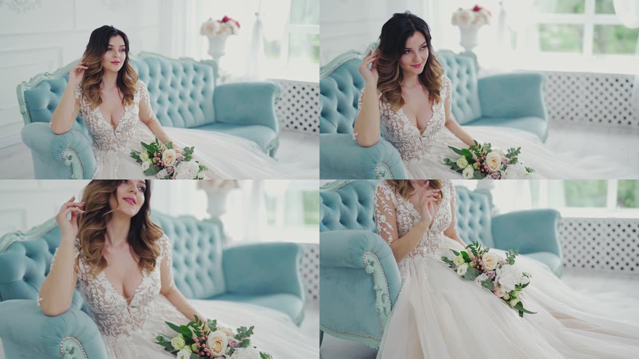 穿着婚纱的魅力新娘坐在家里带花的沙发上。