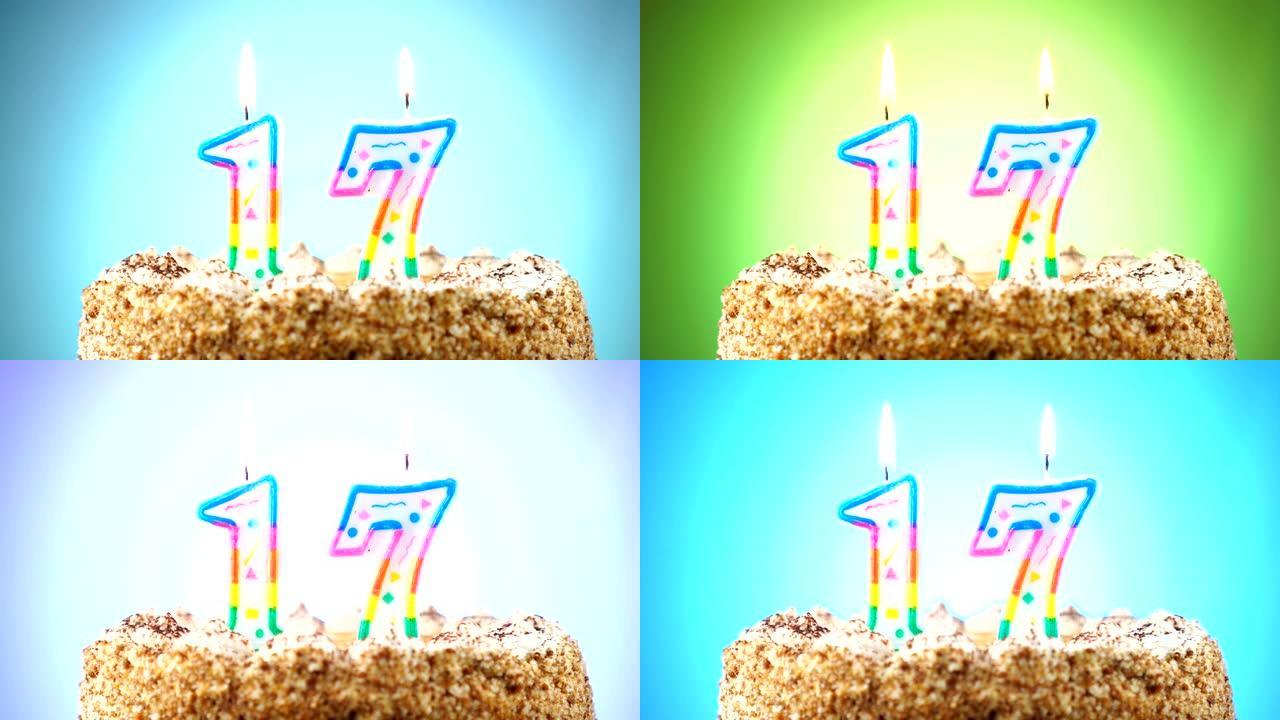 带有燃烧的生日蜡烛的生日蛋糕。17号。背景改变颜色