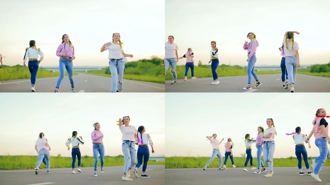夏天在大自然中跳舞。穿着嘻哈牛仔裤的女孩在路上跳舞。