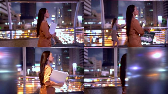 美丽的年轻亚洲妇女走在夜市街道上