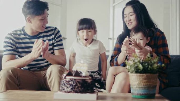亚洲家庭在客厅庆祝年轻女儿生日 (慢动作)