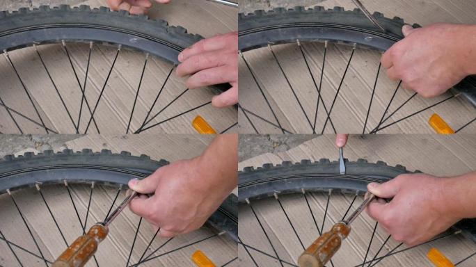 骑自行车的人或机械师修理自行车的轮胎。手和自行车爆胎的特写。
