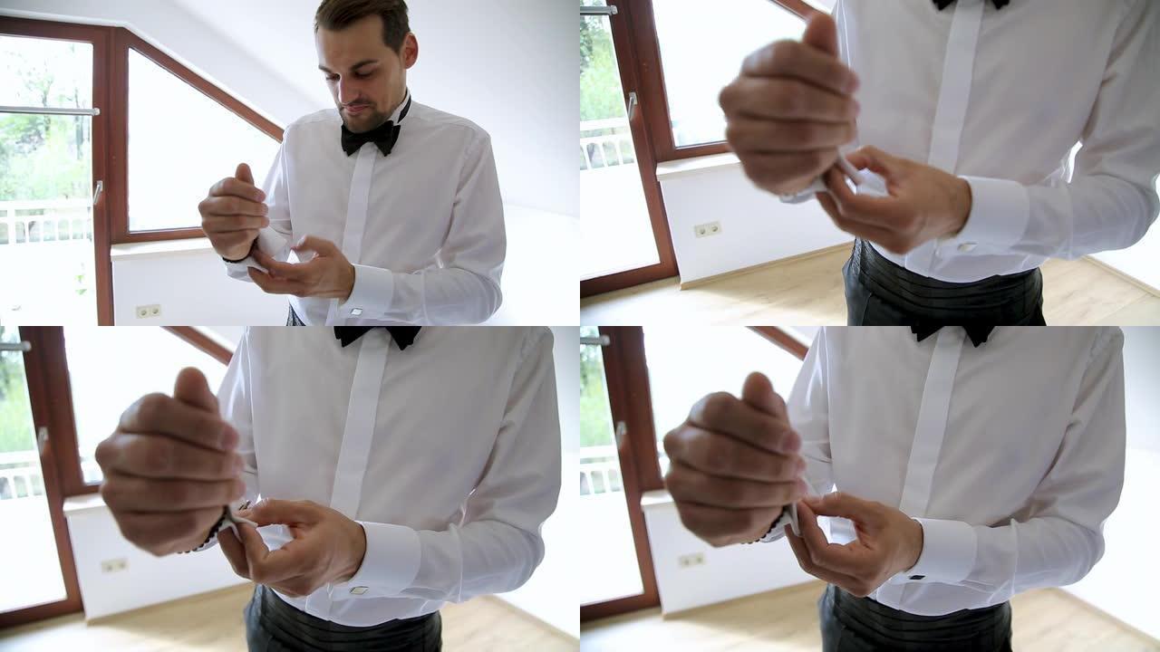 新郎为婚礼做准备。男人在白衬衫上调整袖扣
