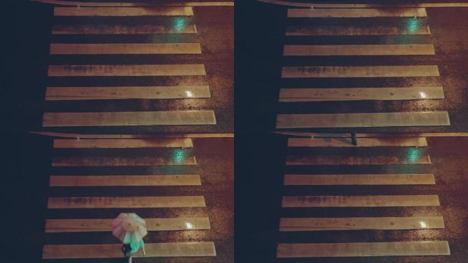 俯视图; 在下雨的夜晚，行人穿过人行横道