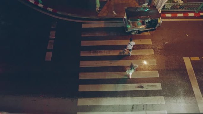 俯视图; 在下雨的夜晚，行人穿过人行横道