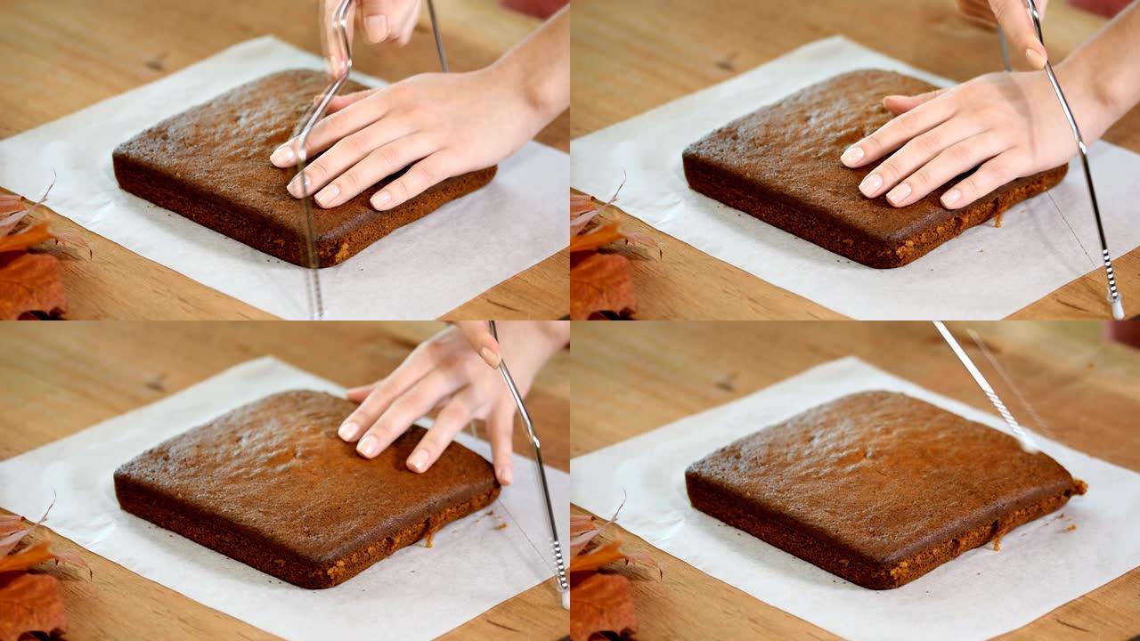 糕点厨师将海绵蛋糕切成层。蛋糕生产过程。