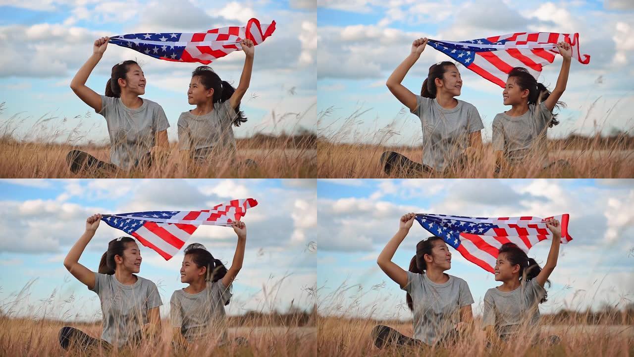 亚洲姐妹快乐和美国国旗美国庆祝7月4日