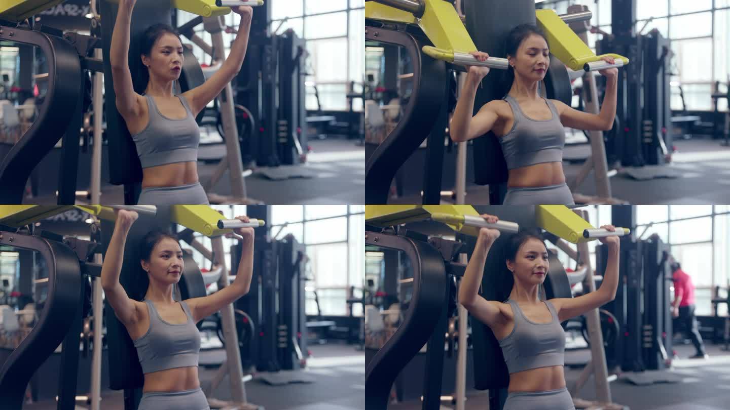 女性穿运动内衣在健身房使用器材锻炼