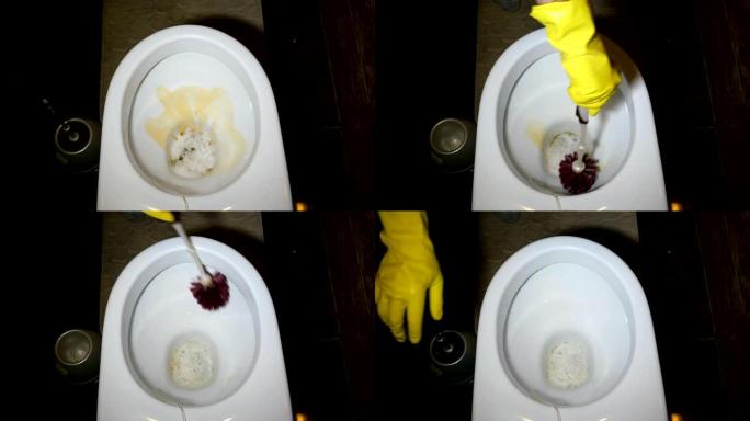 戴着黄色橡胶手套的人的手正在用刷子和马桶洗涤剂洗涤，厕所里的马桶。