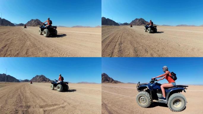 性感的女人在埃及的沙漠里骑着四轮摩托。运动中的动态视图