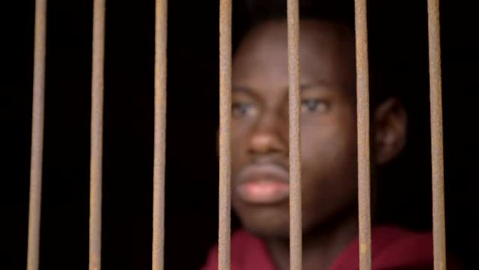 散焦的年轻黑人非洲移民在监狱里。移民，非法