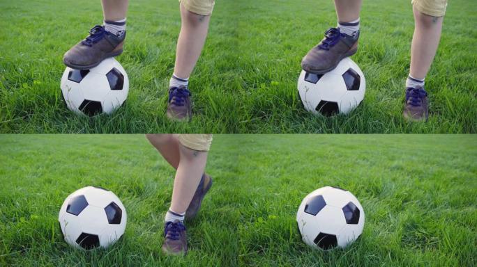 男孩把脚放在足球上。棕色鞋子。破旧运动鞋