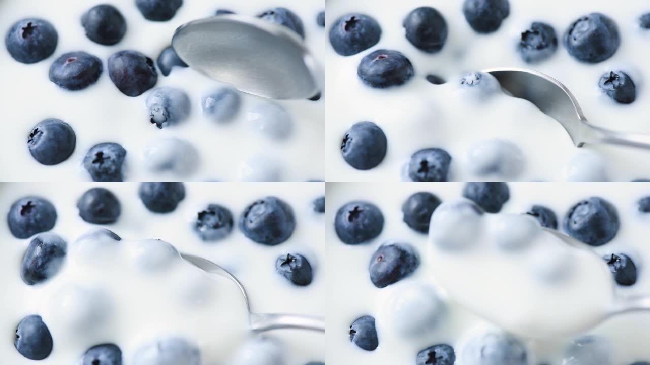 用蓝莓舀酸奶的慢动作
