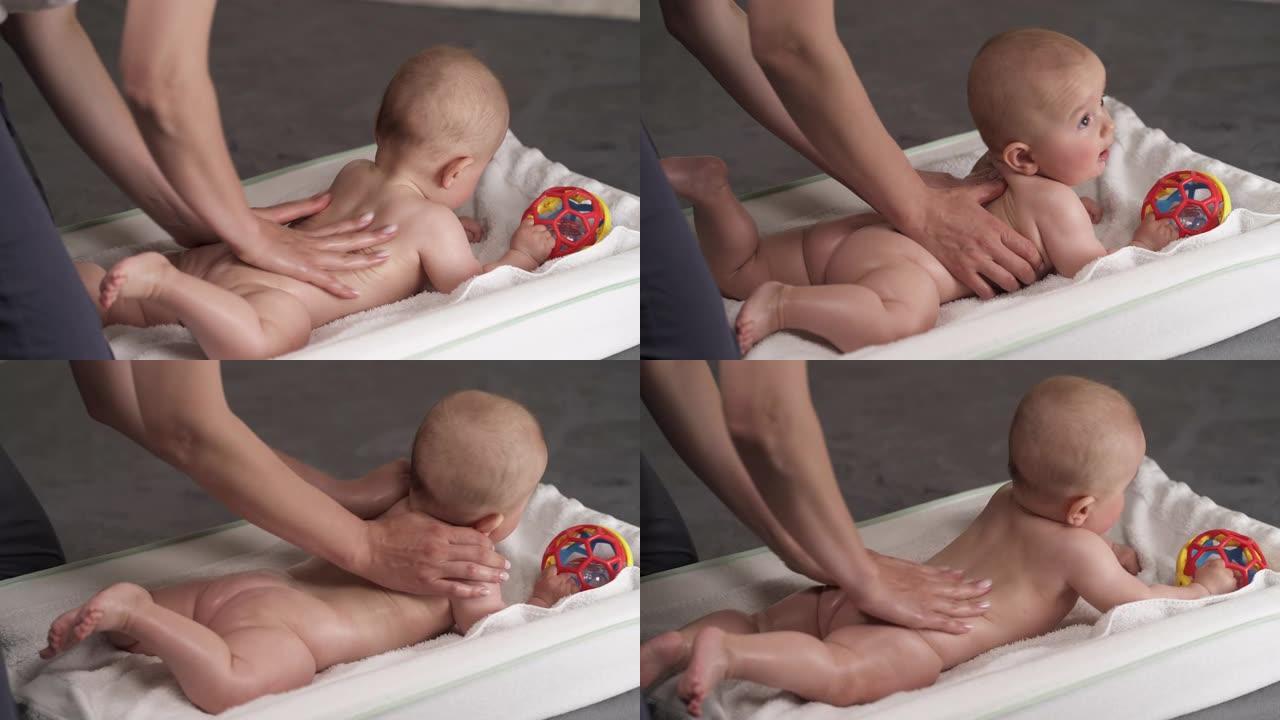 婴儿按摩。母亲给婴儿做按摩。哺乳的孩子。儿童身体护理。
