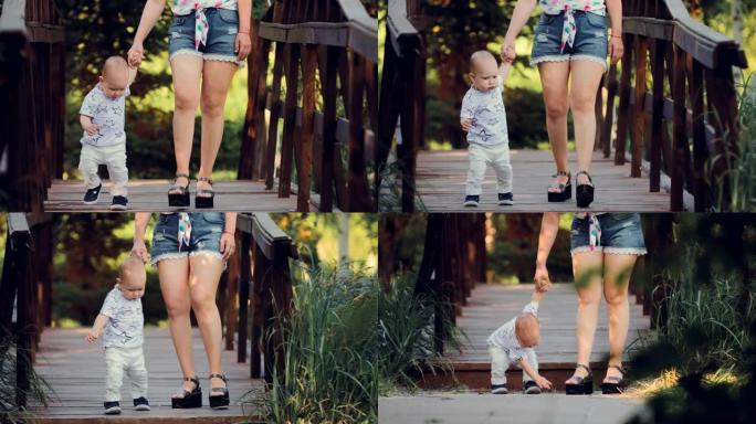 夏天，小婴儿和他的母亲在木桥上的把手边散步。肖像视图。