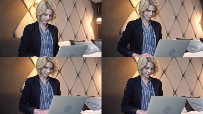一名女商人在旅馆房间里工作笔记本电脑的特写镜头