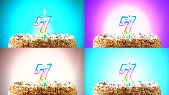 带有燃烧的生日蜡烛的生日蛋糕。7号。背景改变颜色