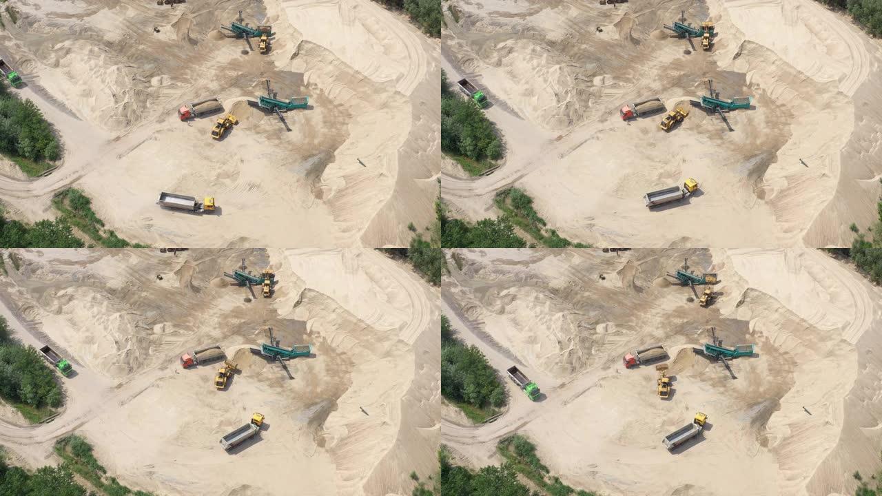 无人驾驶飞机在露天煤矿的推土机上飞行。沙矿。鸟瞰图