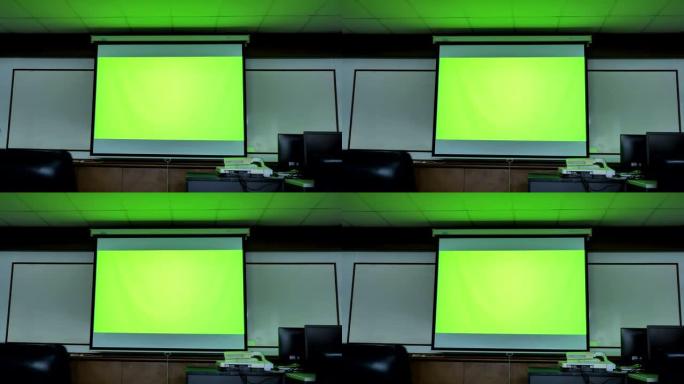 显示绿色色度键屏幕的投影仪屏幕场景站在计算机教室中。技术背景，技术背景的概念