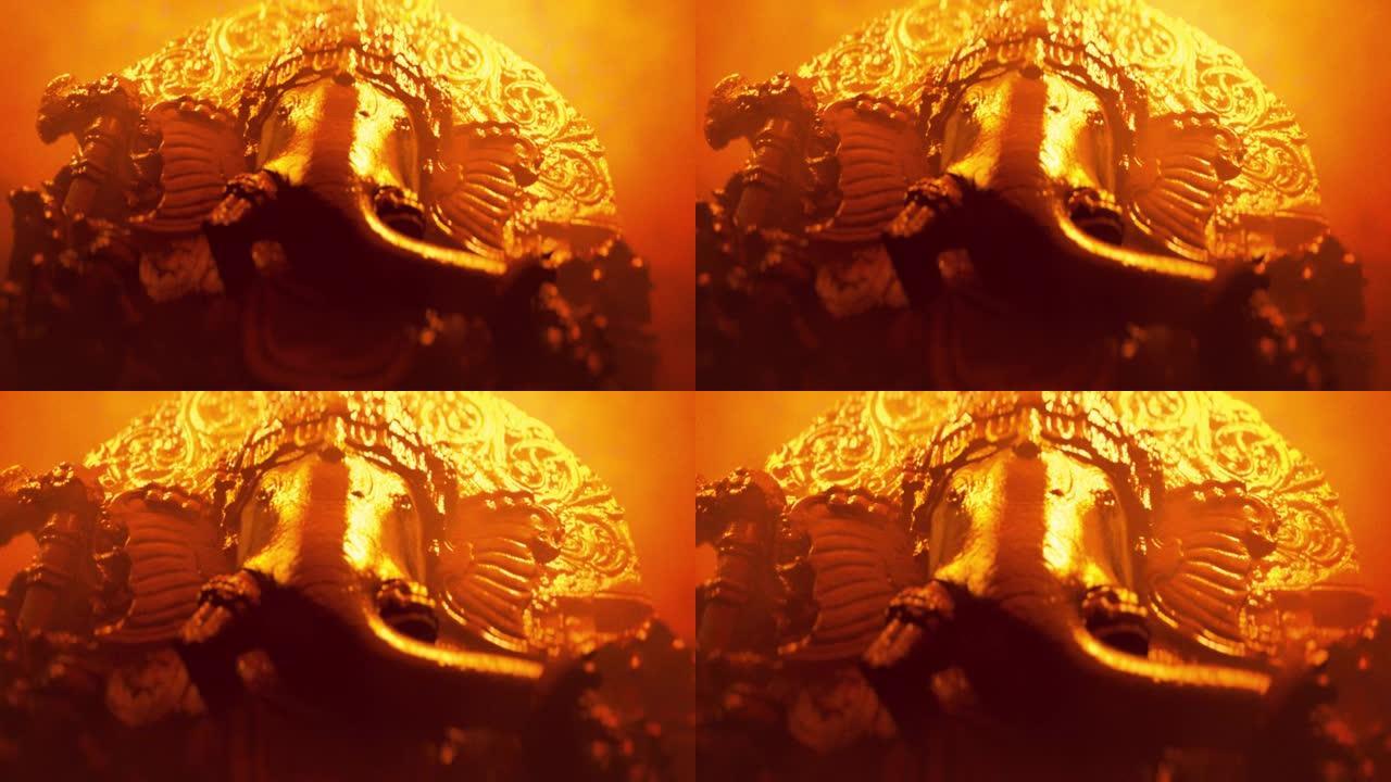 印度教象头神甘尼萨雕塑特写。金色霓虹灯版。