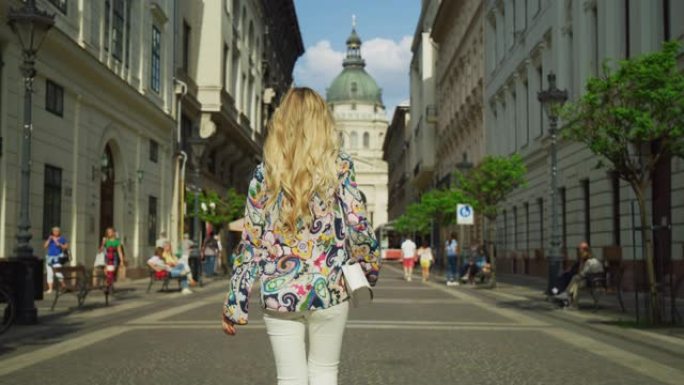一个金发女人走在Zrinyi大街上