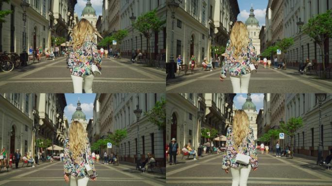 一个金发女人走在Zrinyi大街上