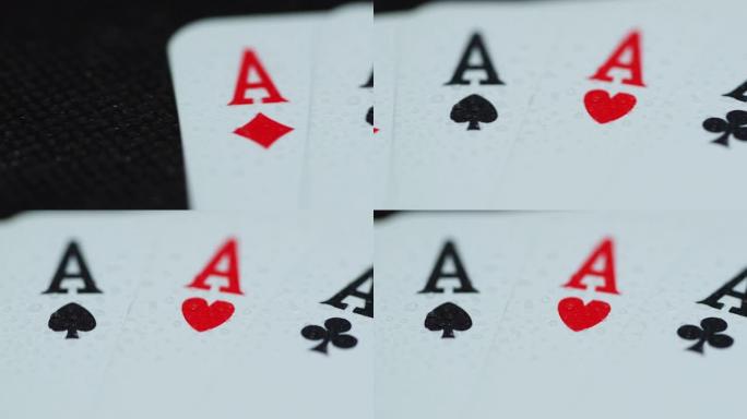 扑克牌顶部的宏观细节拍摄，所有四个ace hearths钻石空间交叉躺在大象上，同时随着纸牌从侧面慢
