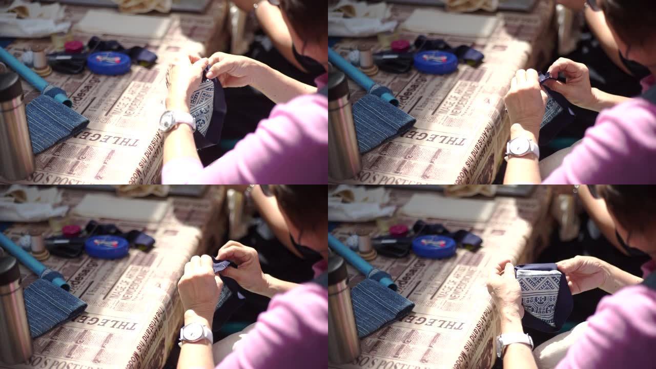 妇女在车间用针缝制拼布，手工制作和手工艺概念。