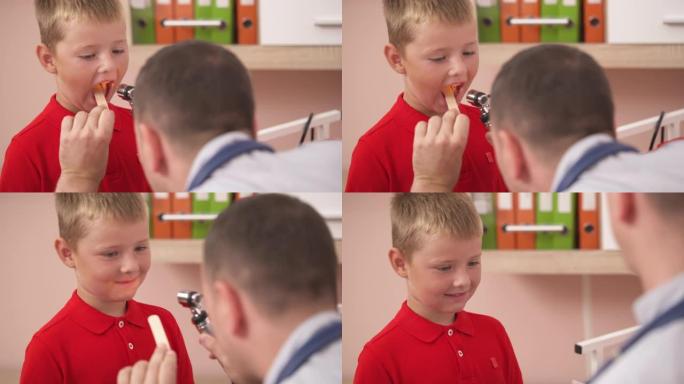 小男孩用压舌板做喉咙检查。耳鼻喉科。儿科概念