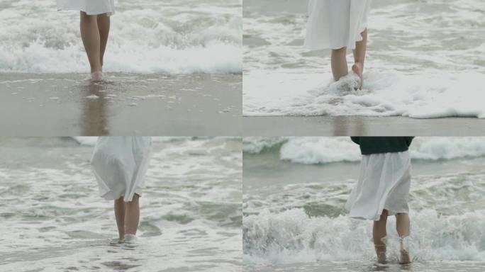 赤裸裸的女性脚踩在微弱的大海中