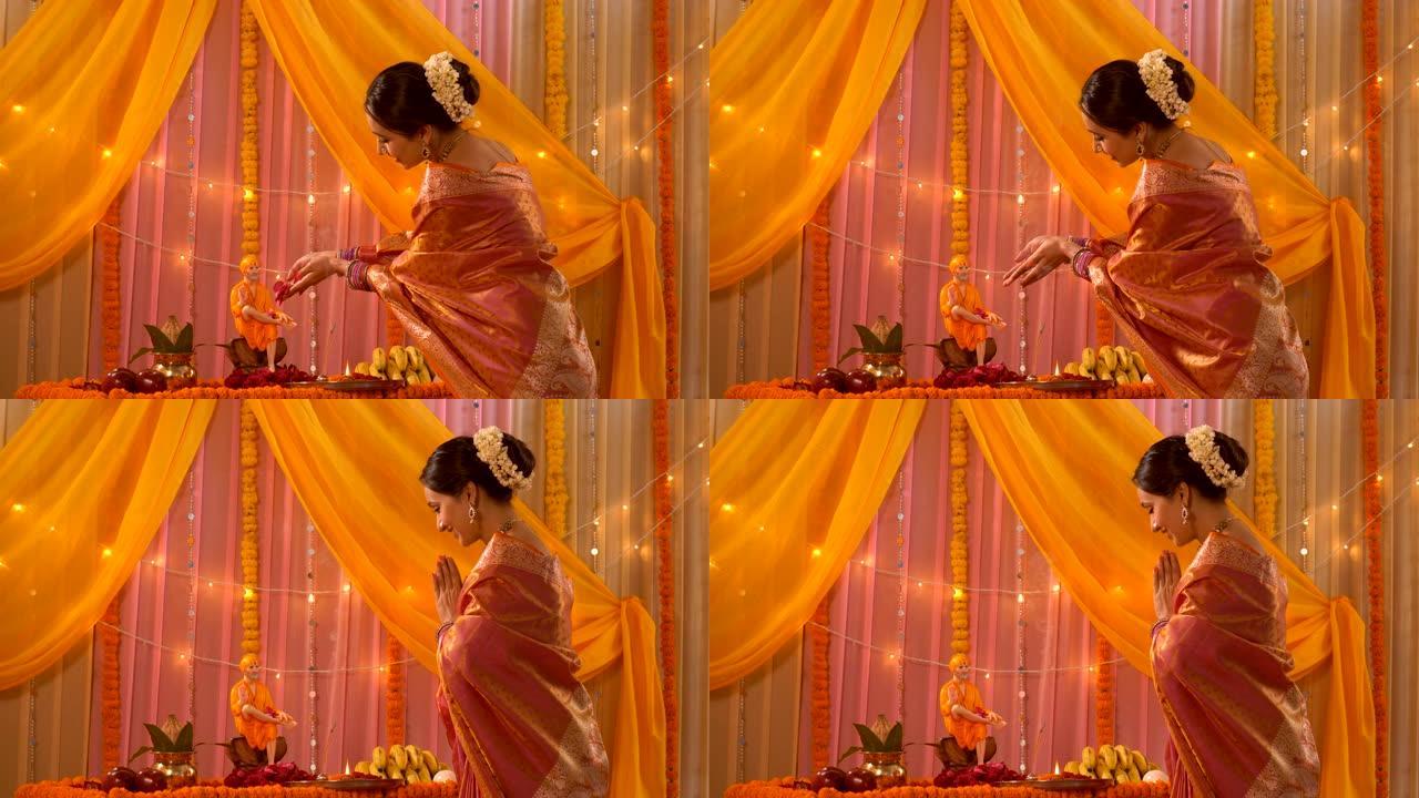 穿着纱丽的美丽印度女人在节日期间微笑着向赛巴巴献花 -- 古鲁·普尔尼玛