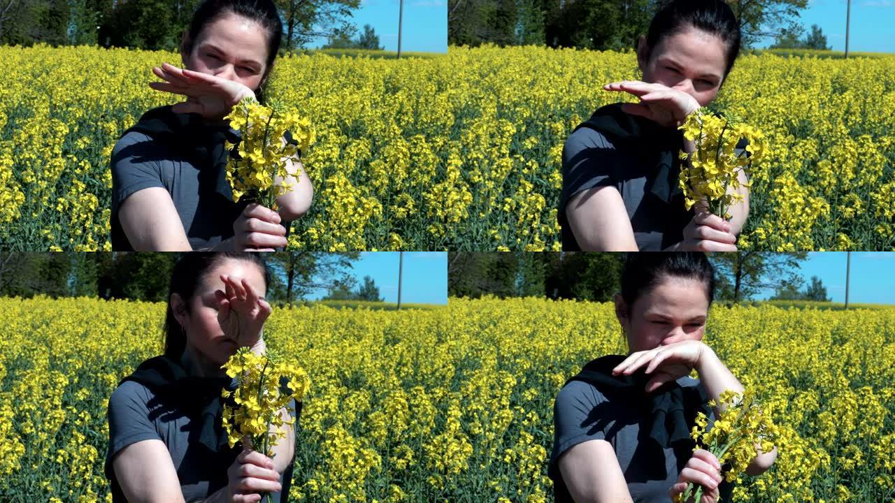 黄色油菜籽田的女人吹鼻子，花粉过敏