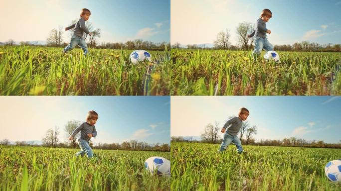 SLO MO小男孩在草地上踢足球