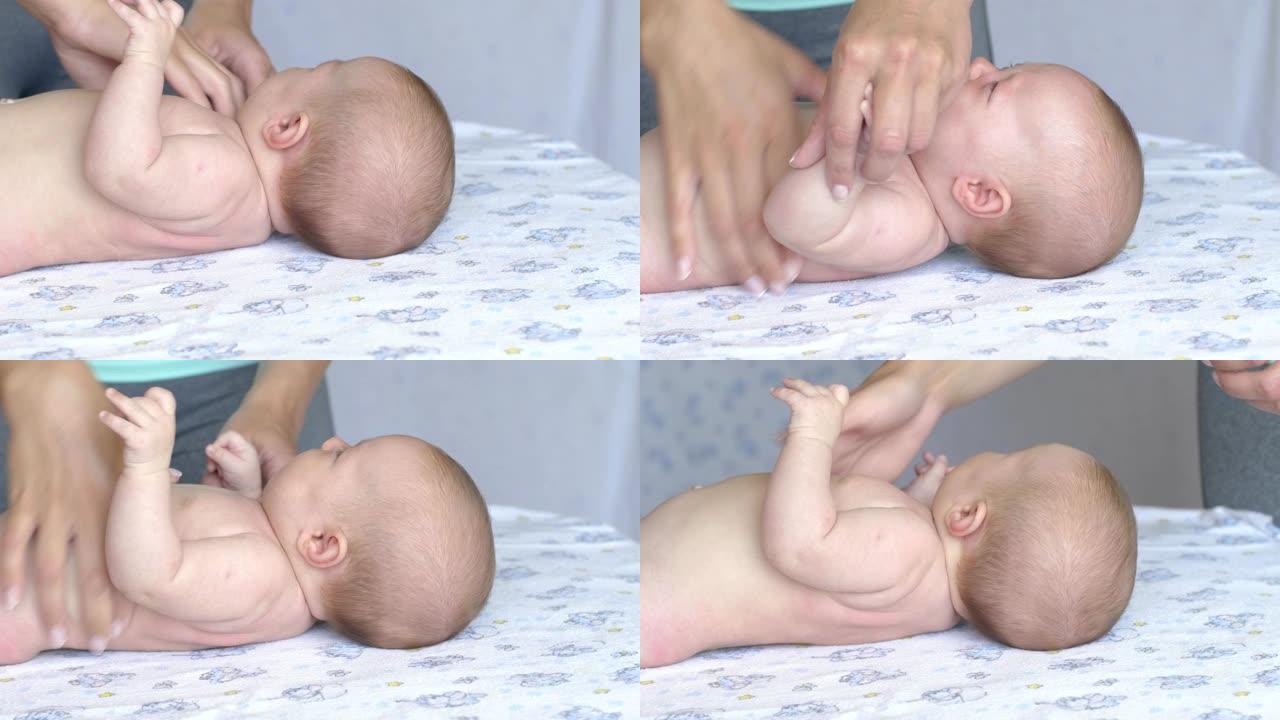 按摩专业治疗师为两个月大的女婴做儿童康复按摩
