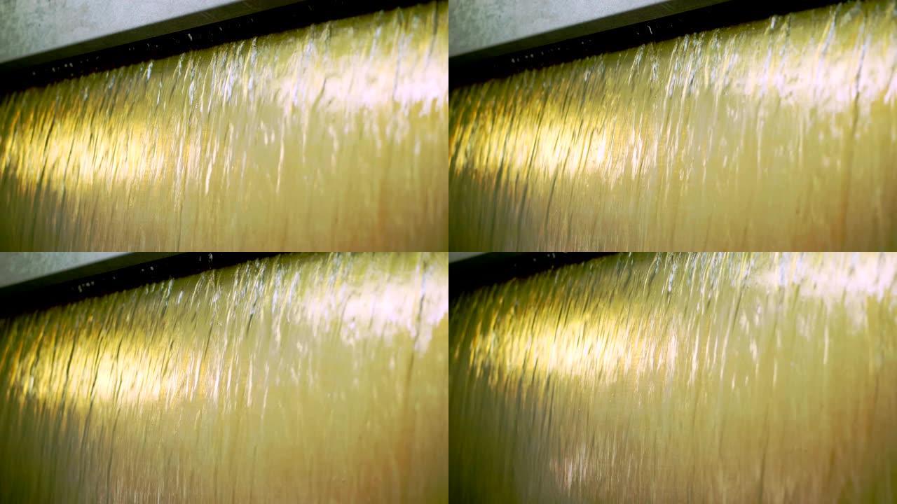 特写镜头。在一种特殊的机器中，流动着一种淡黄色的液体家具漆。用清漆覆盖家具外立面