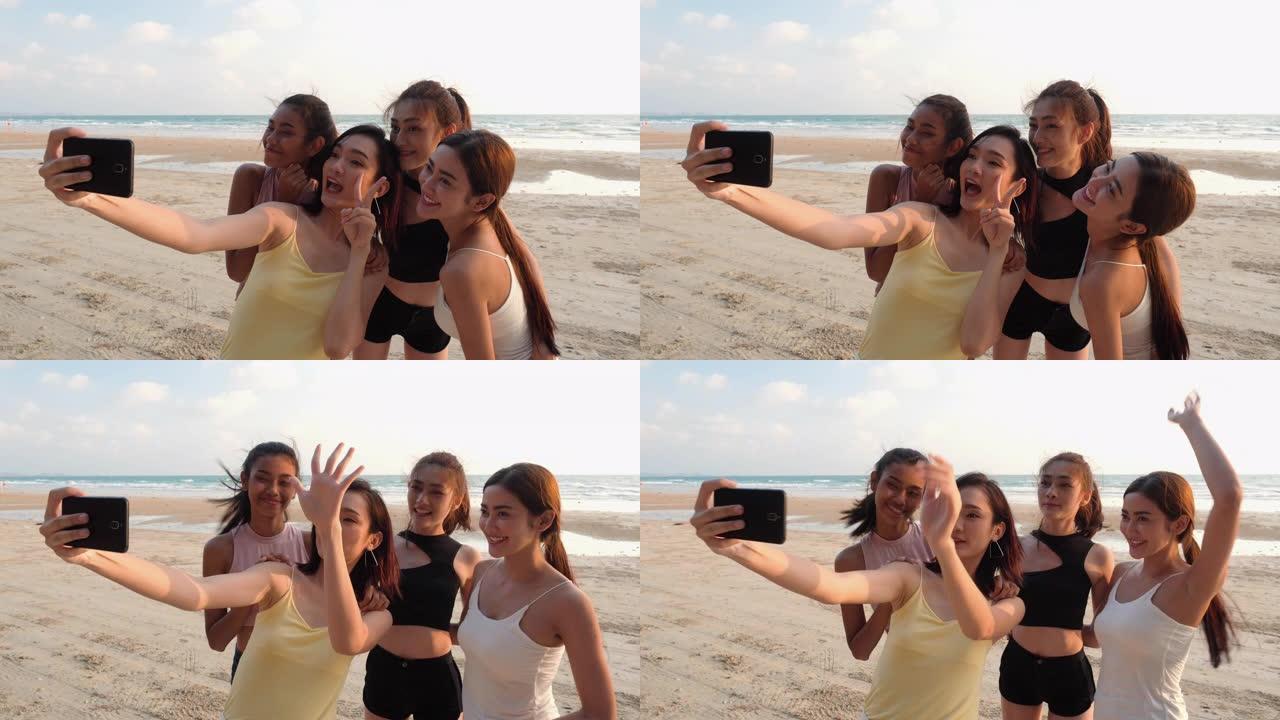 亚洲女团摄影自拍与智能手机一起在海边海滩夏天。青年亚洲快乐情感和周年庆典。4k分辨率和慢动作。