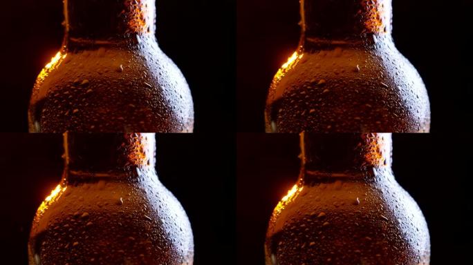 闪亮冰冷啤酒瓶颈的特写镜头，背景孤立在黑色上