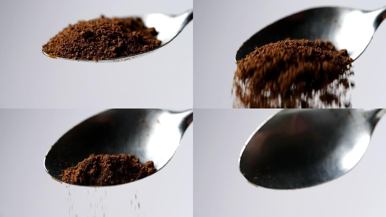 一汤匙咖啡。咖啡粉从勺子中缓慢落下