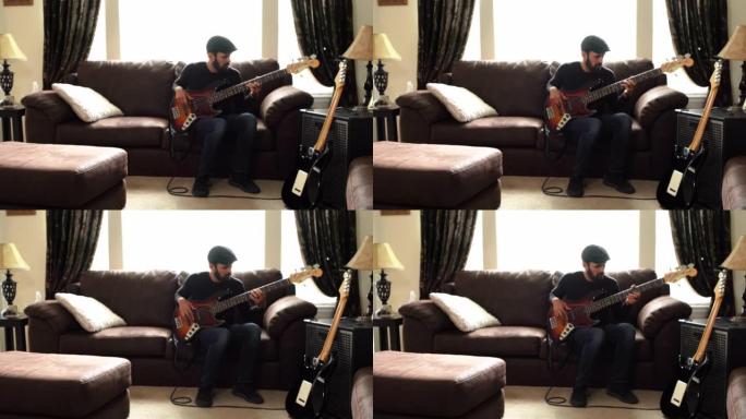 一个才华横溢的年轻人在客厅里练习低音吉他的视频剪辑