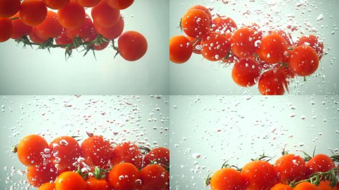水中落下的樱桃番茄。慢动作。