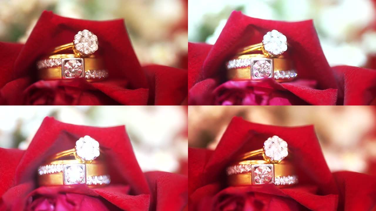 背景模糊的红玫瑰结婚戒指的宏观照片。