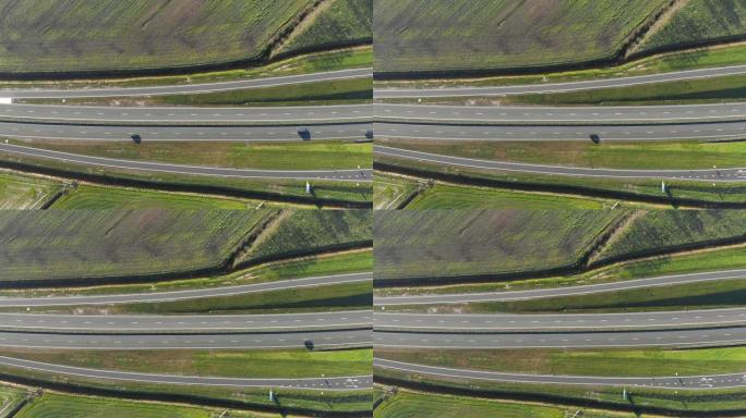 鸟瞰图在连接荷兰主要城市的高速公路附近飞行。汽车在高速公路上的运动。