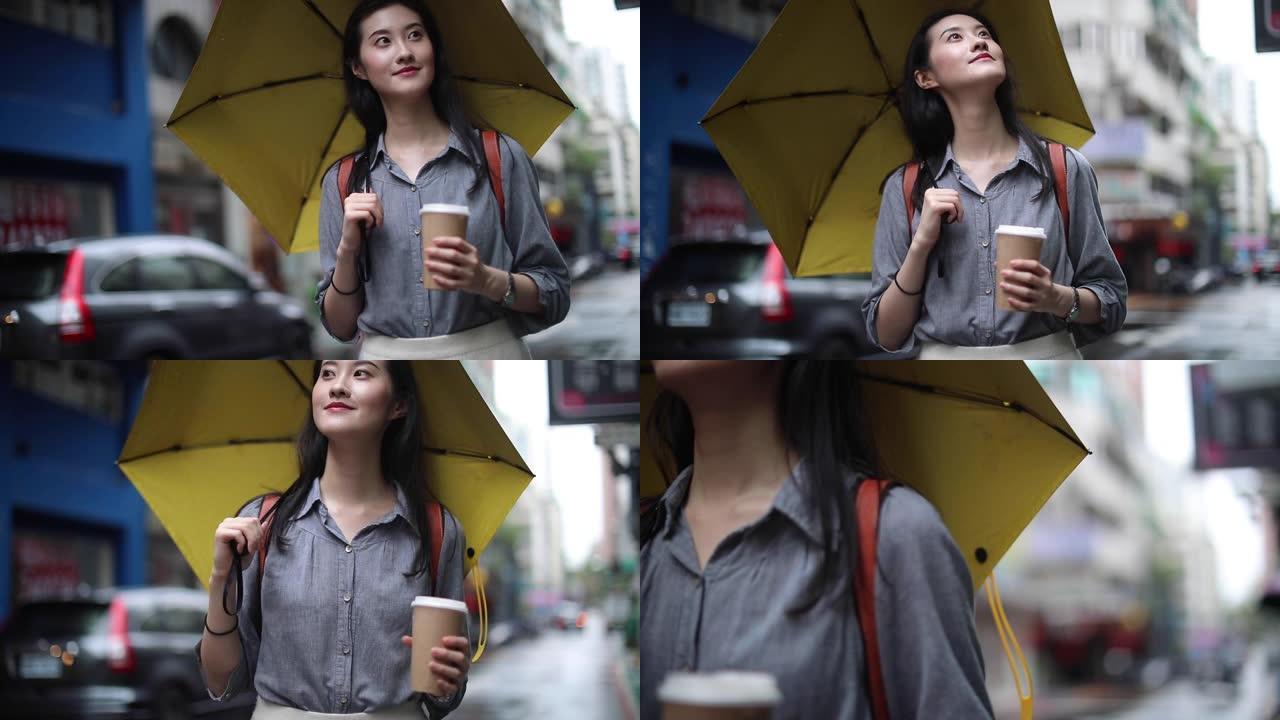 亚洲妇女下雨天走在街上